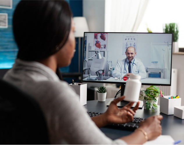 Healthcare professional using a laptop with holographic medical icons